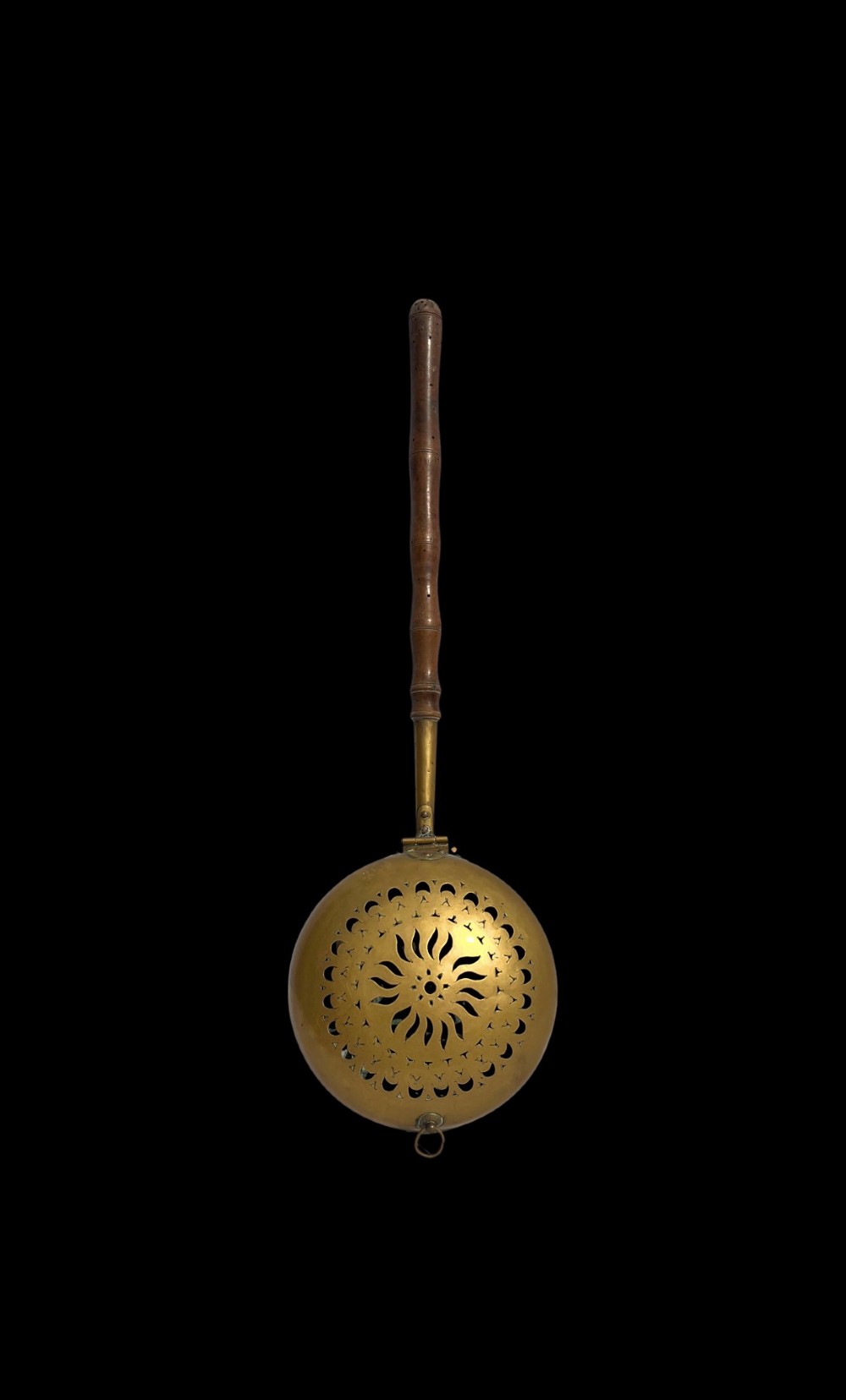An antique English brass bed warming pan featuring a pierced decorative lid and a turned wooden handle. View II