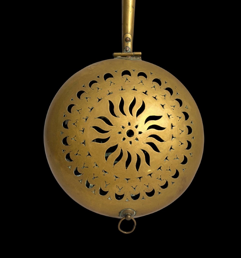 An antique English brass bed warming pan featuring a pierced decorative lid and a turned wooden handle. View III