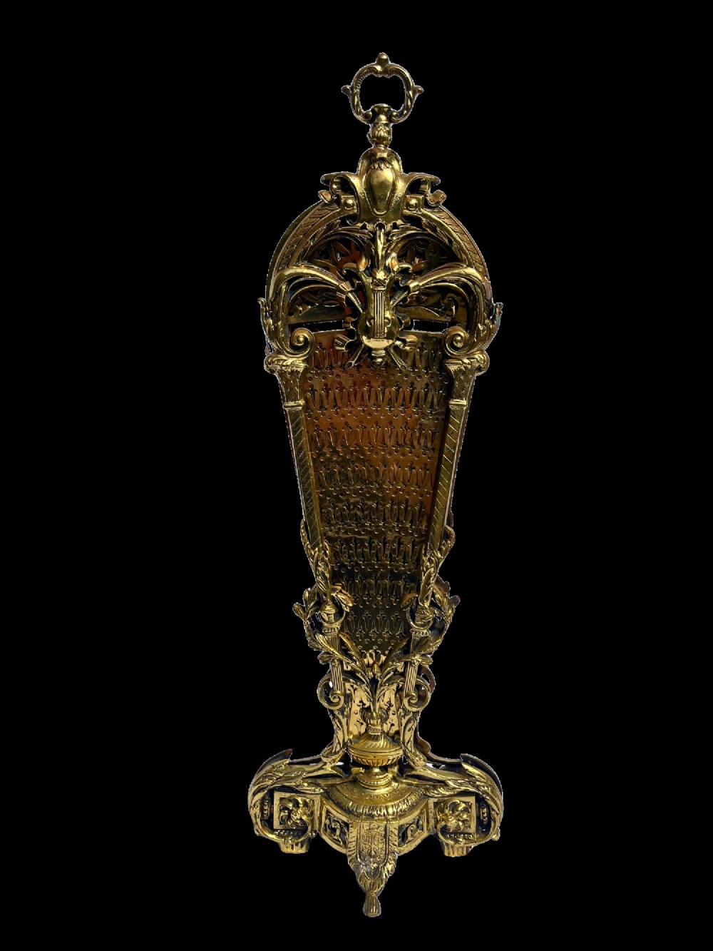An antique folding brass fan fire screen featuring pierced filigree leaves and an ornate cast central handle. View V