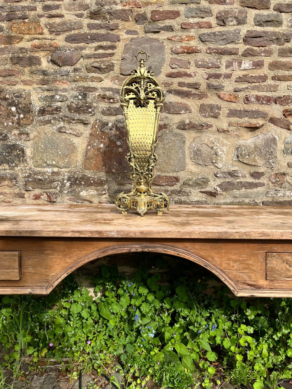 An antique folding brass fan fire screen featuring pierced filigree leaves and an ornate cast central handle. View VII