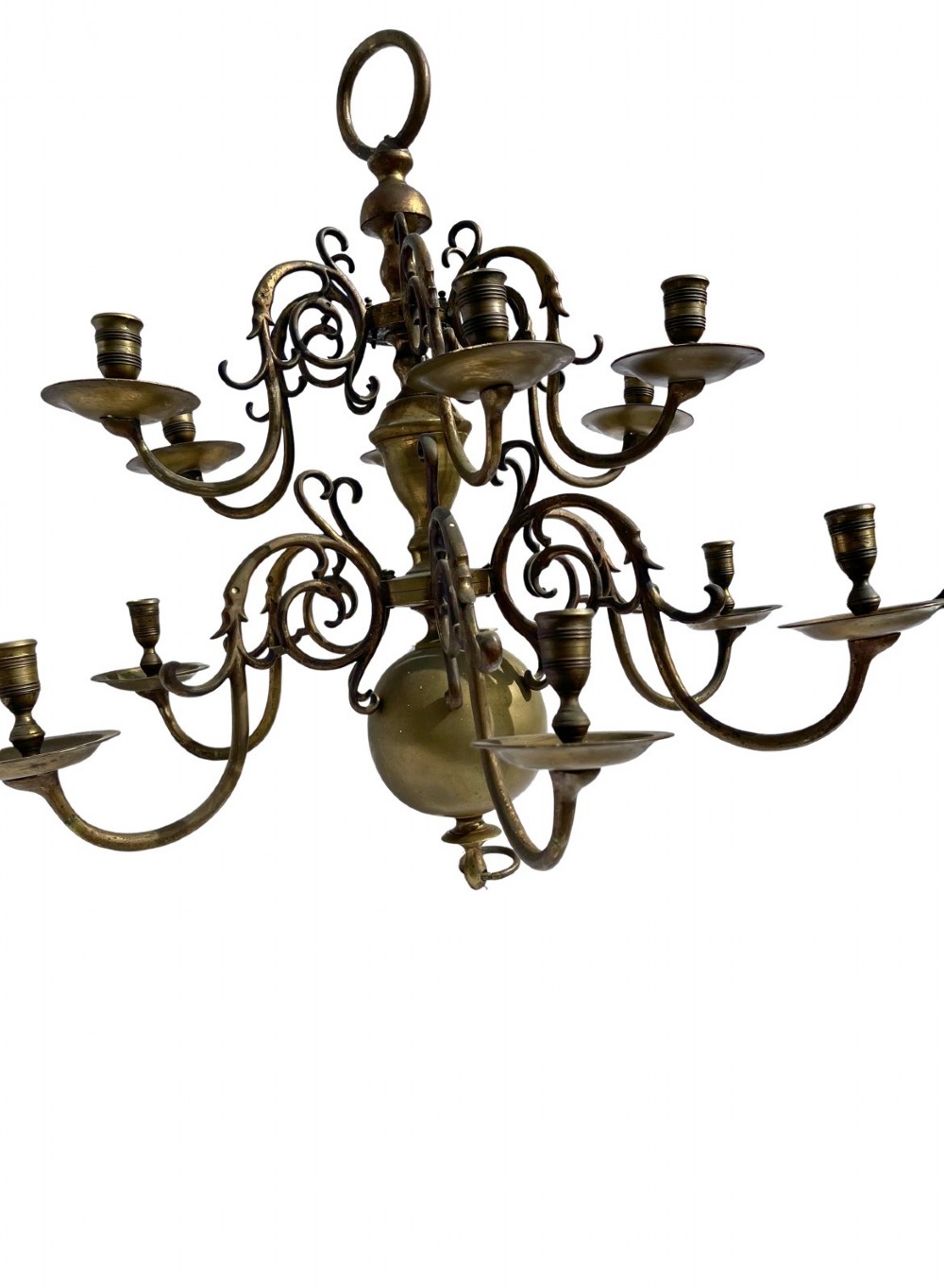 A late nineteenth-century multi-arm brass chandelier featuring scrolling candle branches, a central baluster stem, and a spherical base globe.