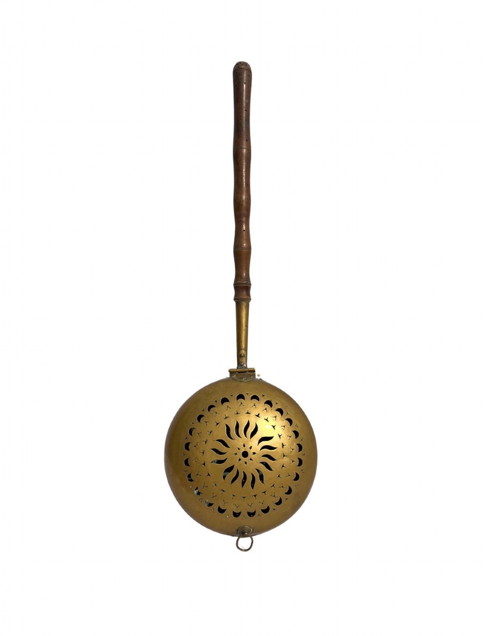 An antique English brass bed warming pan featuring a pierced decorative lid and a turned wooden handle.