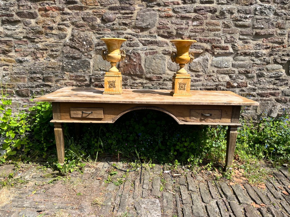 Pair of yellow veined Sienna marble campana urns featuring brass ram head handles and square plinths decorated with floral appliques. View IV