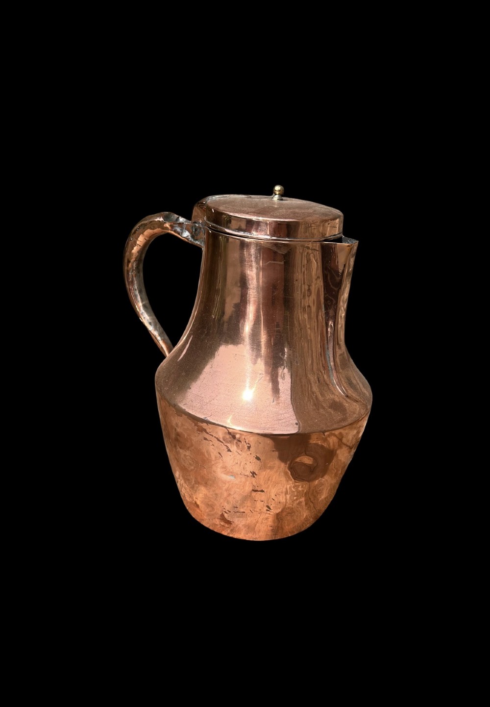 A polished antique copper milk jug featuring a hinged lid, small top finial, and a broad curved handle. View II