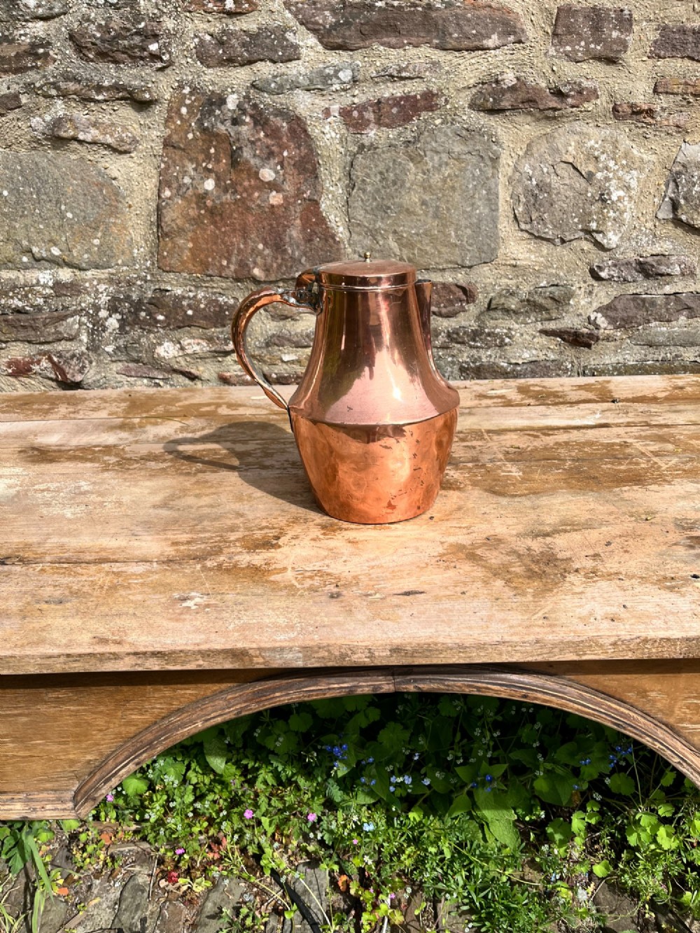 A polished antique copper milk jug featuring a hinged lid, small top finial, and a broad curved handle. View IV