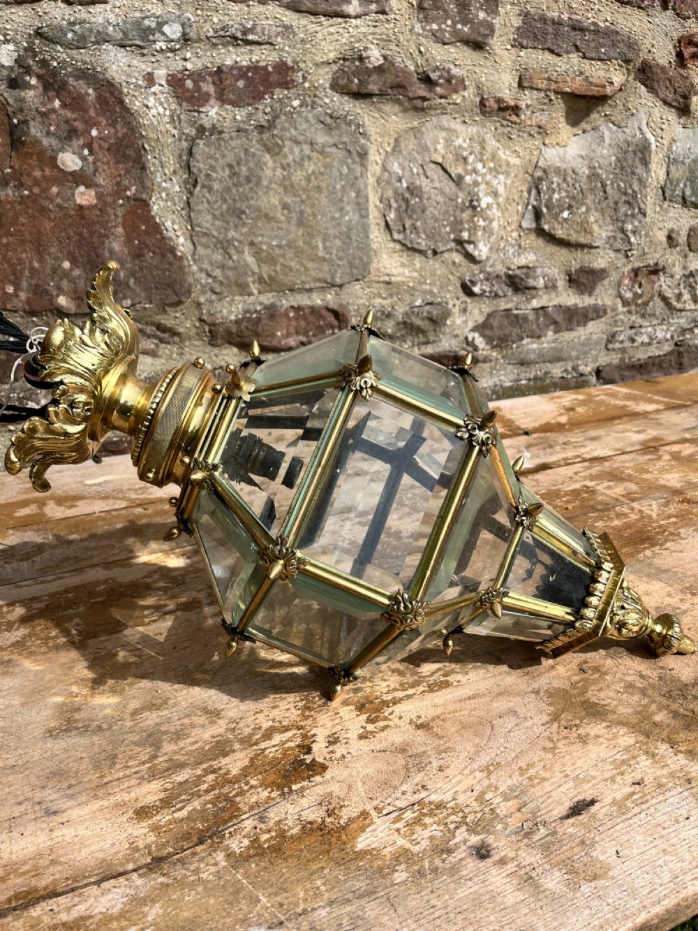An ornate Versailles style French brass hanging lantern featuring bevelled glass panels, cast metal mouldings, and a leaf motif crown. View III
