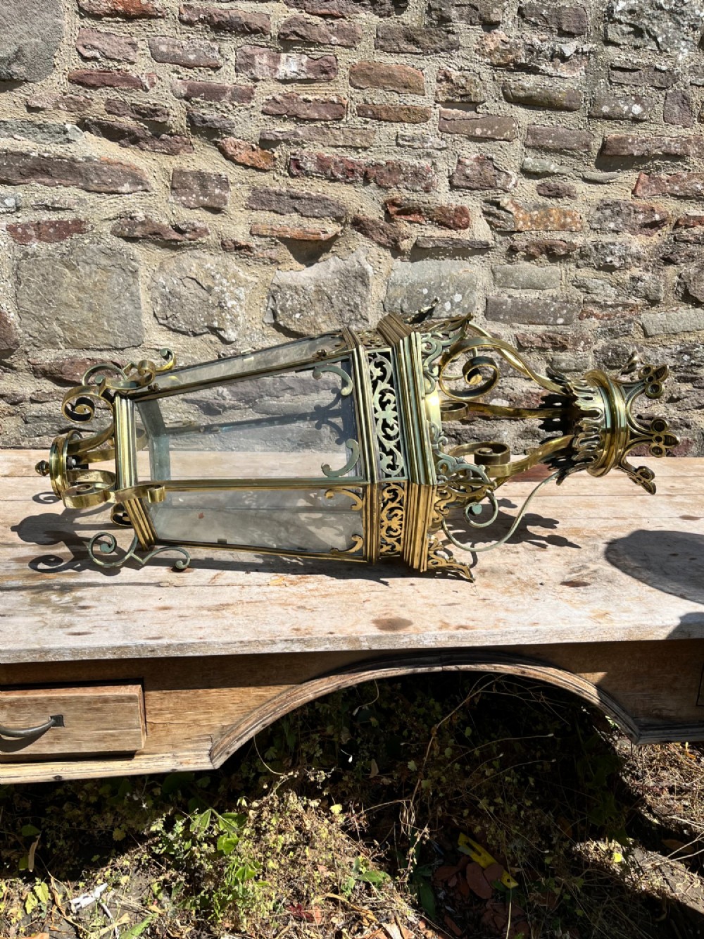A large ornate brass hanging hall lantern featuring glazed glass panels, a coronet crown top, pierced metal fretwork, and scrollwork accents. View III