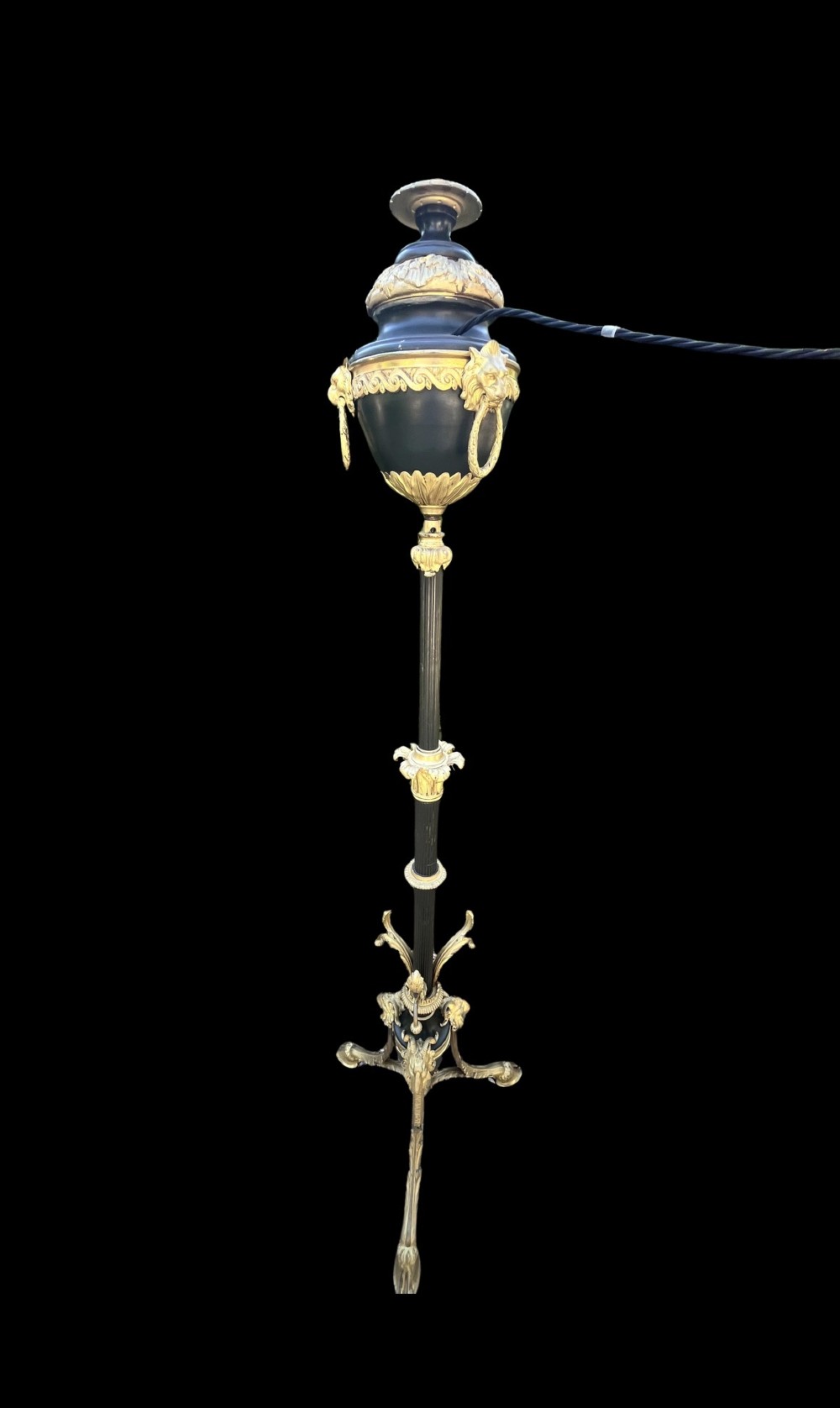 A Victorian gilt bronze and black patinated metal standard floor lamp with a lion mask urn top section, fluted shaft, and tripod paw feet. View II