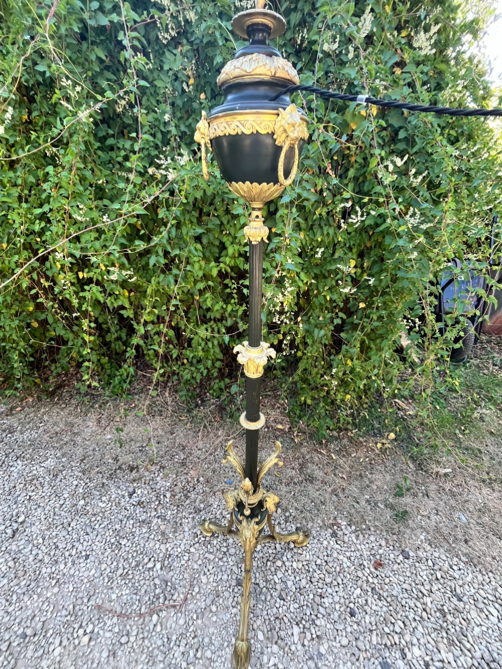 A Victorian gilt bronze and black patinated metal standard floor lamp with a lion mask urn top section, fluted shaft, and tripod paw feet. View III