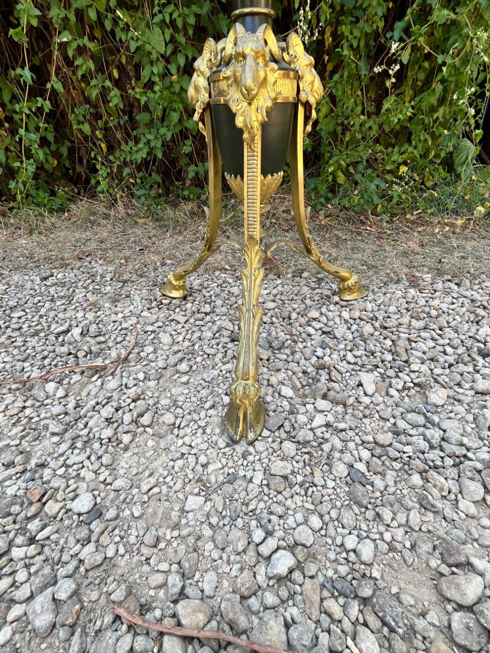 A Victorian gilt bronze and black patinated metal standard floor lamp with a lion mask urn top section, fluted shaft, and tripod paw feet. View VI