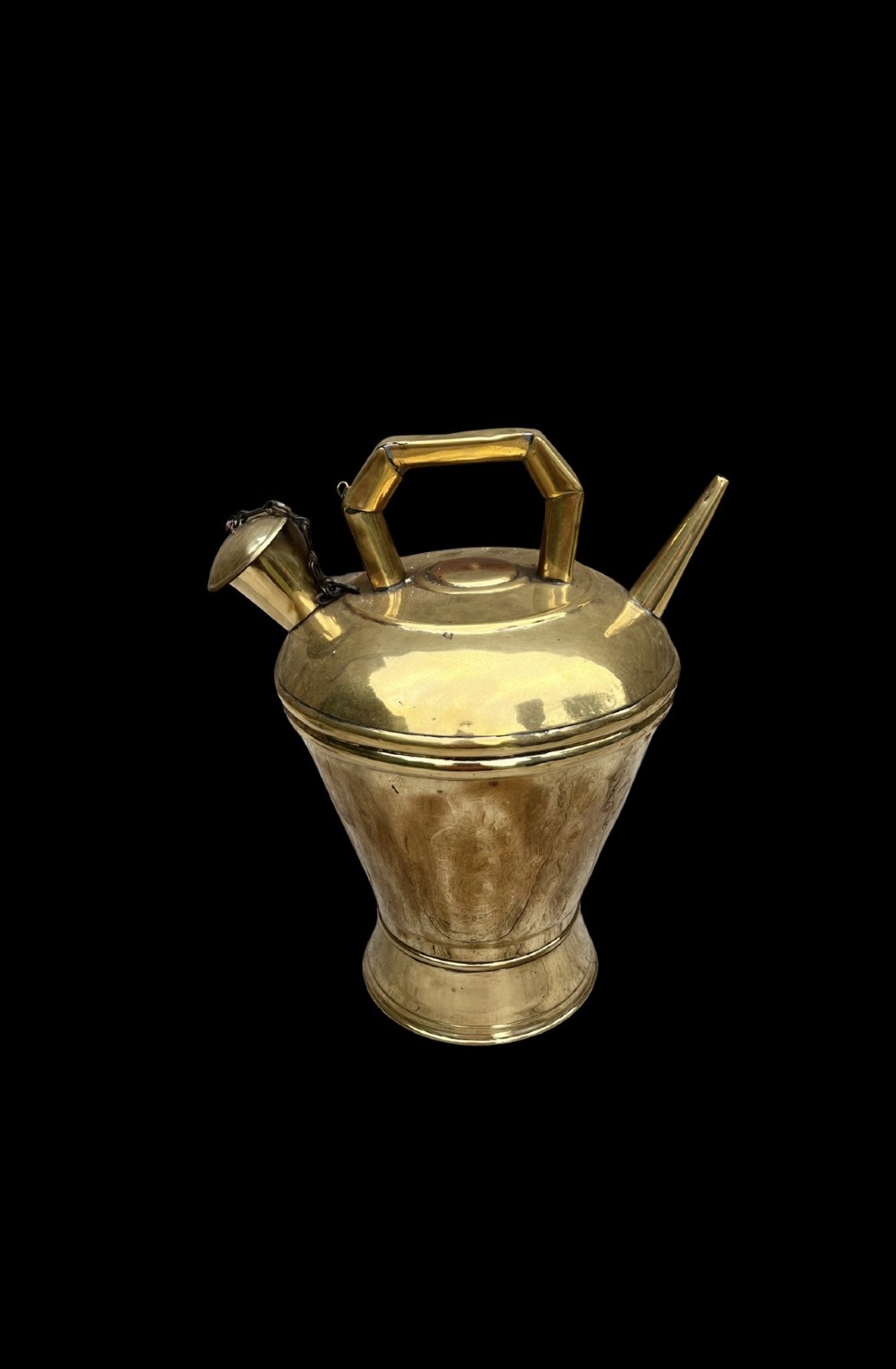 An antique polished brass oil vessel featuring an angular top handle, a long thin pouring spout, and a capped filler spout on a pedestal base. View II