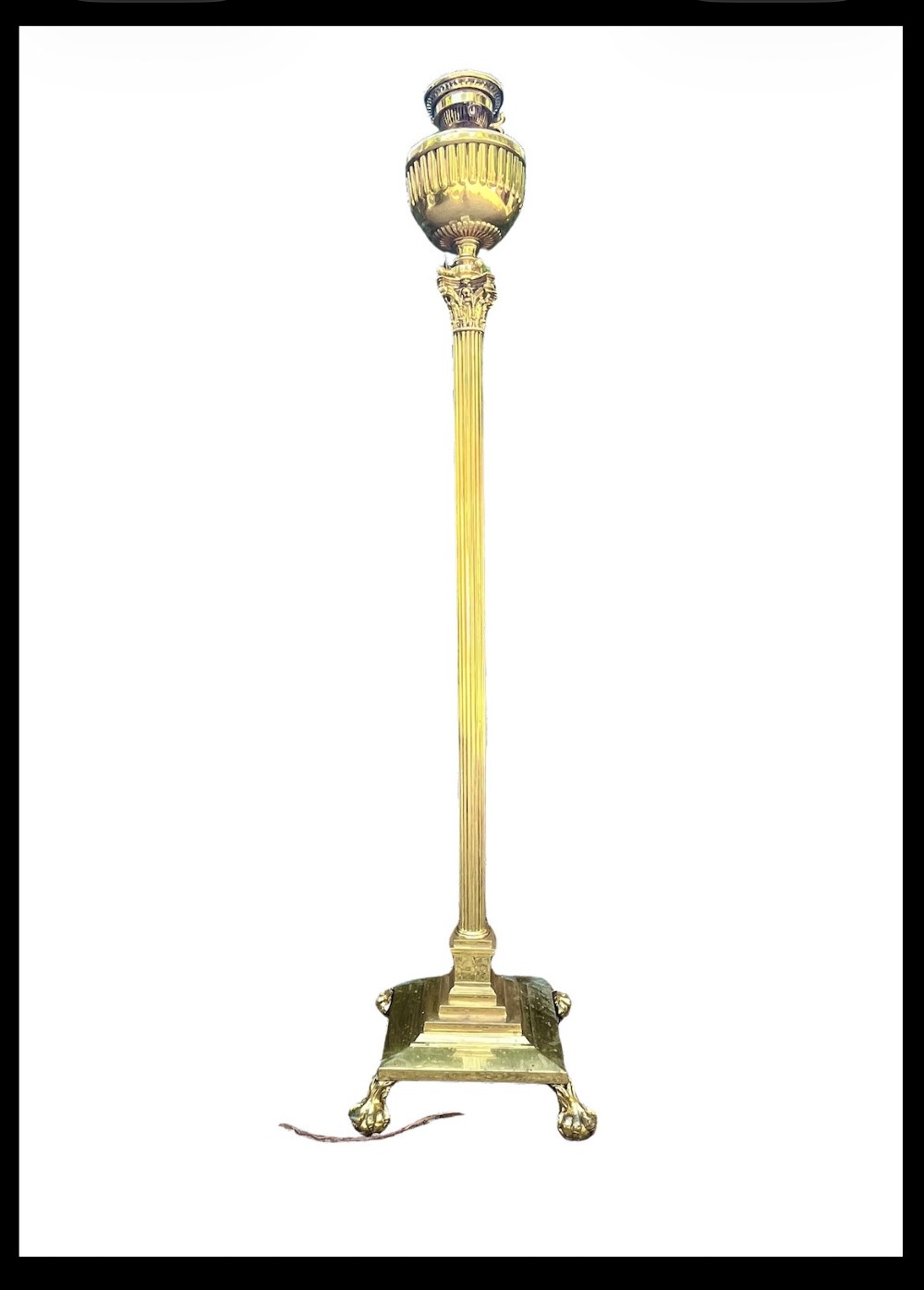 A solid brass floor lamp featuring a fluted Corinthian column stem, an urn-shaped reservoir top, and a stepped square base supported by claw feet.