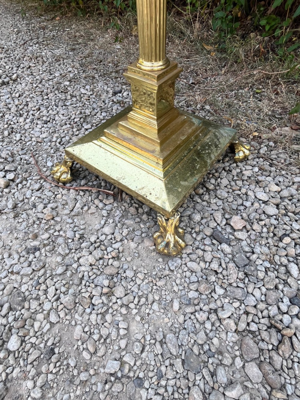 A solid brass floor lamp featuring a fluted Corinthian column stem, an urn-shaped reservoir top, and a stepped square base supported by claw feet. View V