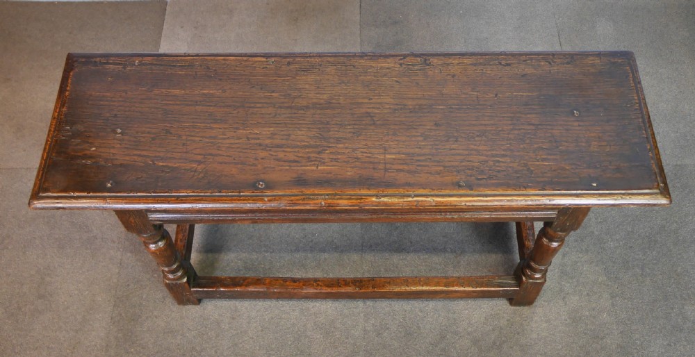 A low rectangular dark oak coffee table featuring baluster-turned legs, block feet, and a surrounding low box stretcher. View IX