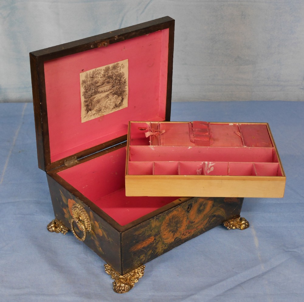 An antique Regency wooden jewellery box with painted floral decorations, gilt ring handles, and ornate brass claw feet. View VI