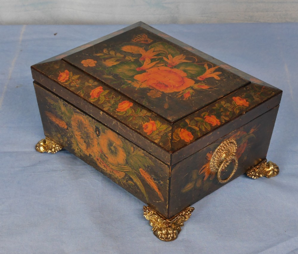 An antique Regency wooden jewellery box with painted floral decorations, gilt ring handles, and ornate brass claw feet. View XI
