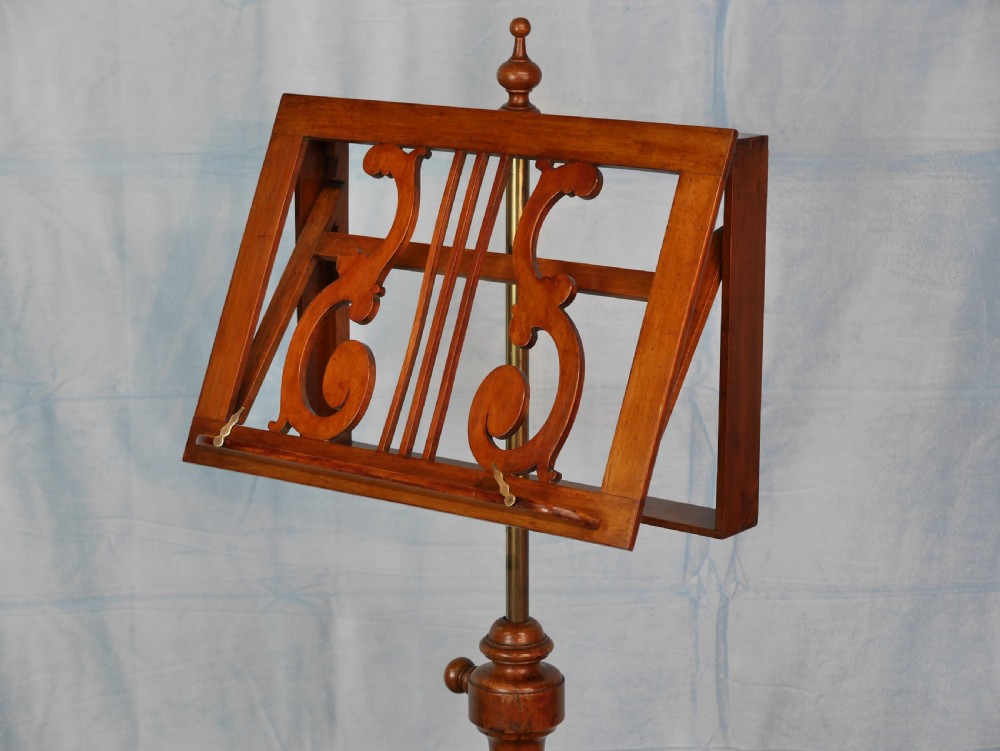 A Victorian mahogany adjustable music stand featuring an openwork lyre-patterned book rest, turned central column, and a tripod base. View IV