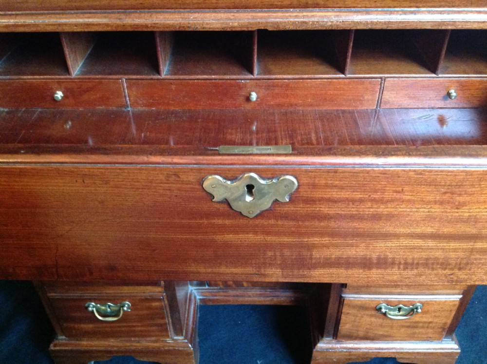 An 18th-century mahogany secretaire kneehole desk featuring brass swan-neck handles, side drawers, and bracket feet. View XIII