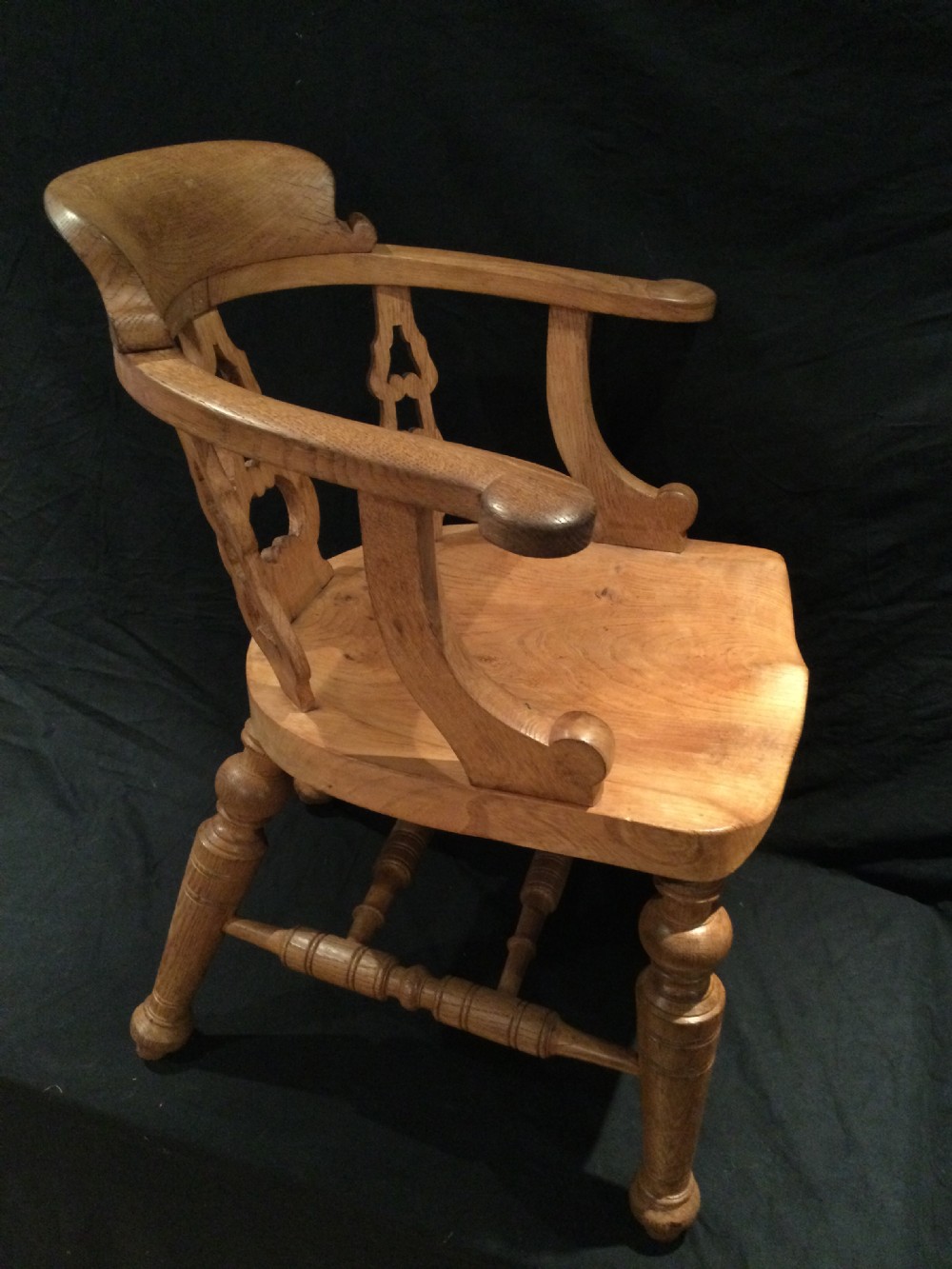 Set of four Victorian light brown wooden captains armchairs with curved backrests, pierced splats, shaped saddle seats, and turned legs. View VIII