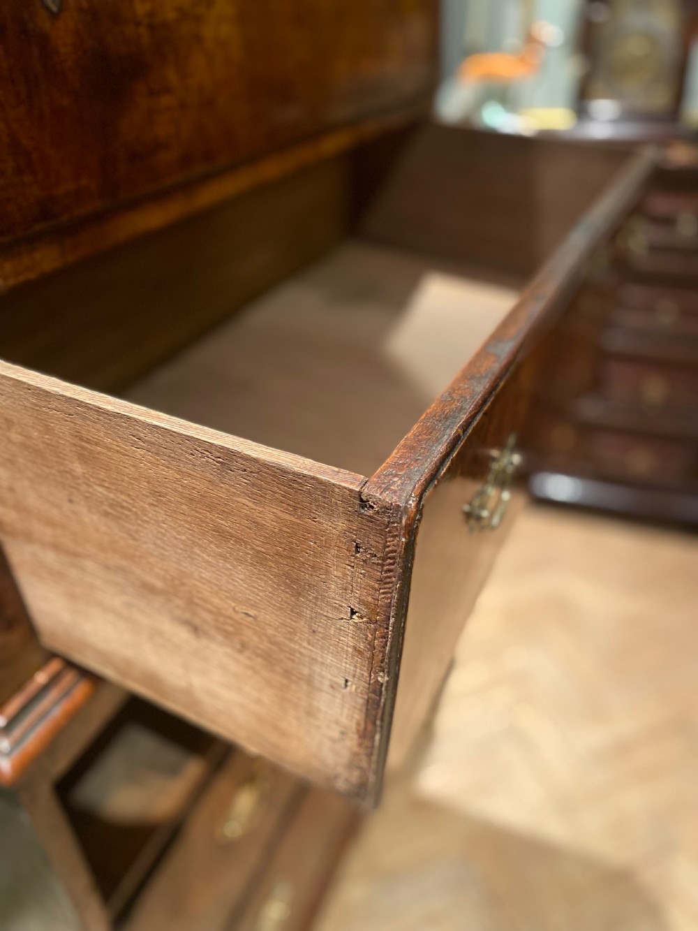 A tall Georgian burr walnut chest-on-chest featuring stacked drawers with brass drop handles and bracket feet. View XI