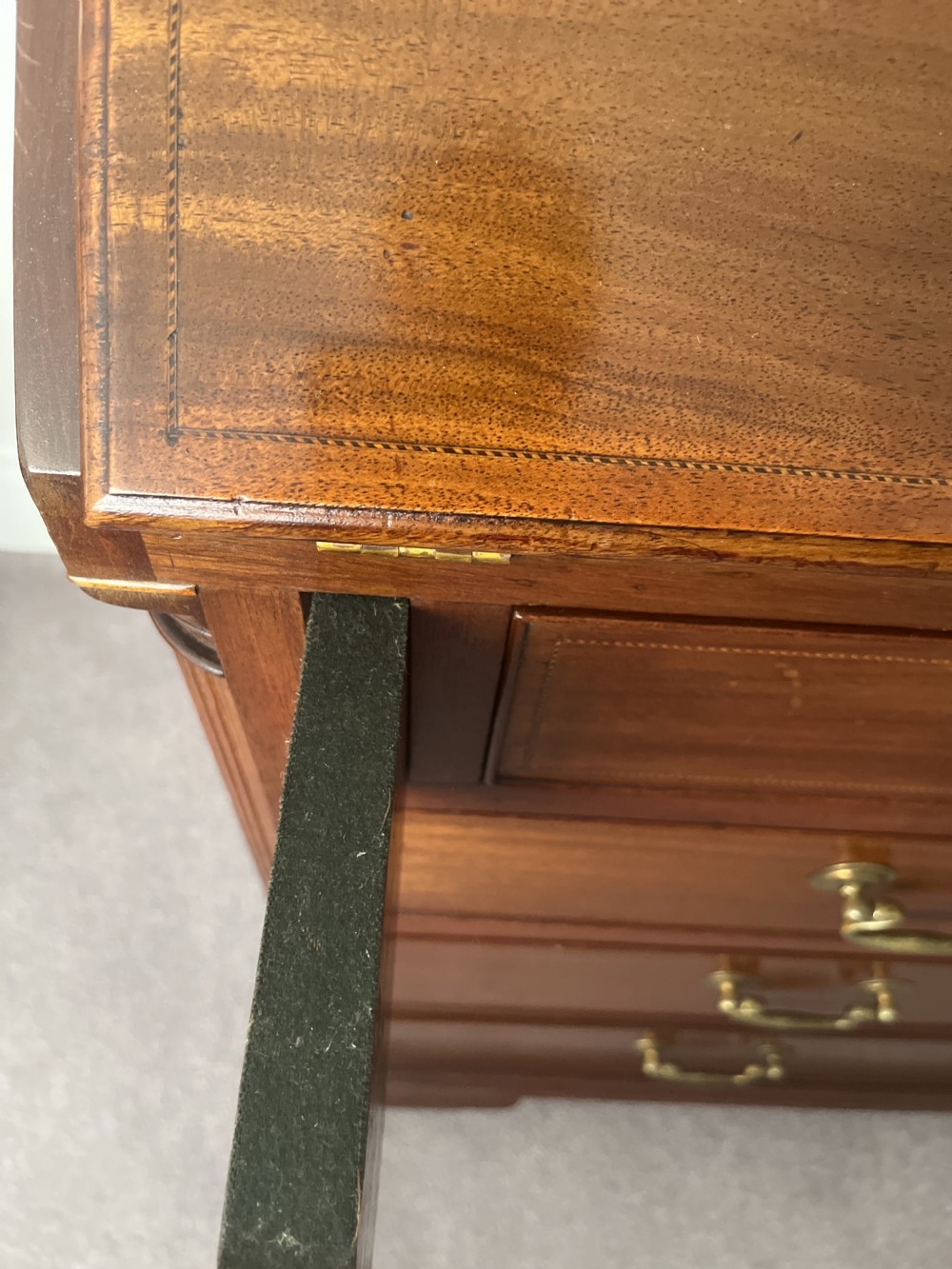 A Georgian mahogany writing bureau featuring a sloped hinged lid above four graduating drawers with brass swan-neck handles. View VII