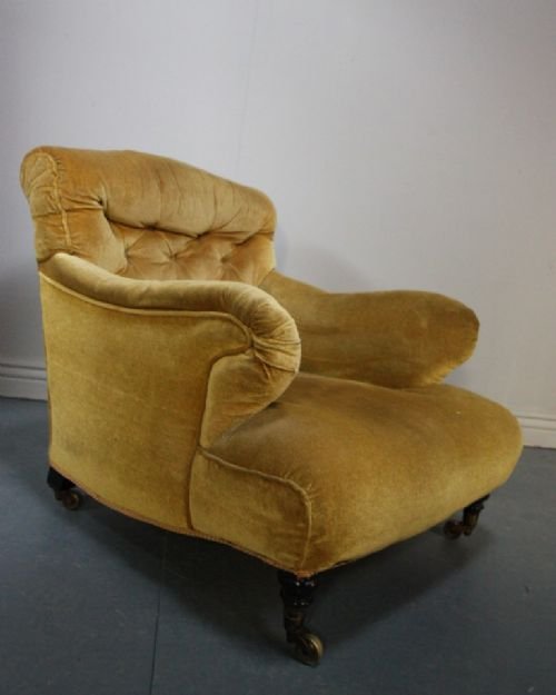 Antique Upholstered Armchair. Very Howardesque.