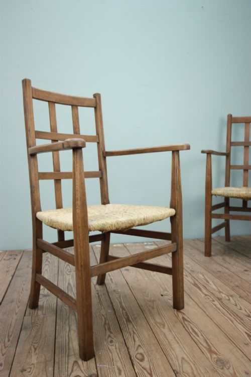 A Rare Pair of Heals Antique Oak Armchairs.