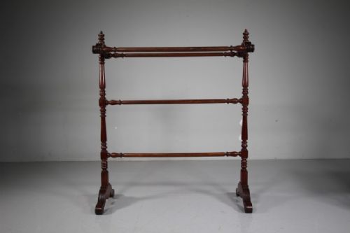 A freestanding mahogany towel rail featuring turned upright columns, finials, carved scroll feet, and multiple horizontal crossbars. View V