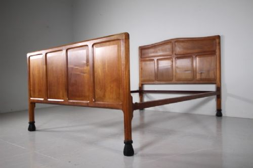 A 1920s pale walnut double bed frame featuring framed panelwork on both the headboard and footboard. View VIII