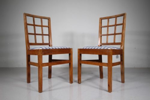 Set of six warm brown wooden dining chairs featuring open grid backrests and plaid upholstered drop-in seats. View II