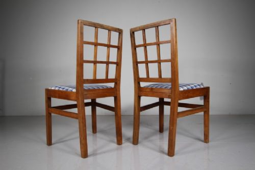 Set of six warm brown wooden dining chairs featuring open grid backrests and plaid upholstered drop-in seats. View III