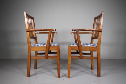 A pair of 1930s solid oak open armchairs featuring vertical slat backs, flattened armrests, and blue and white checked upholstered seats. View II