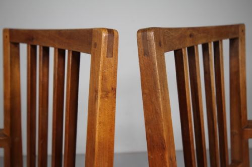 A pair of 1930s solid oak open armchairs featuring vertical slat backs, flattened armrests, and blue and white checked upholstered seats. View VII