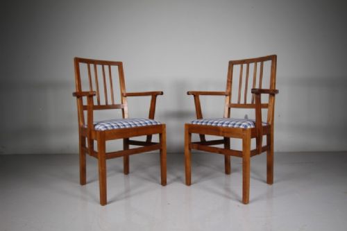 A pair of 1930s solid oak open armchairs featuring vertical slat backs, flattened armrests, and blue and white checked upholstered seats. View IX