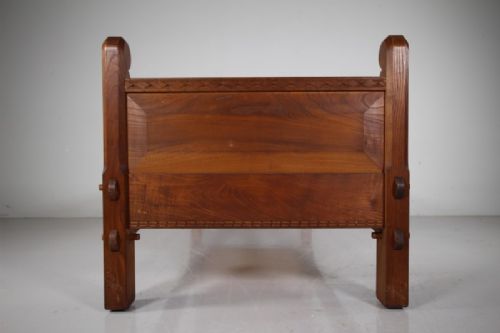 A 1930s solid oak single bed frame featuring carved geometric detailing, panelled headboard and footboard, and sturdy corner posts. View III