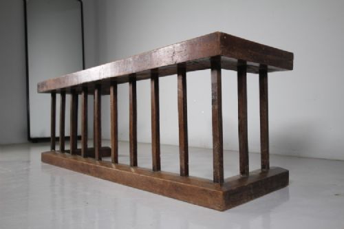 A 19th-century solid oak club fender featuring vertical spindle supports, a flat top wooden seat, and open return ends. View V
