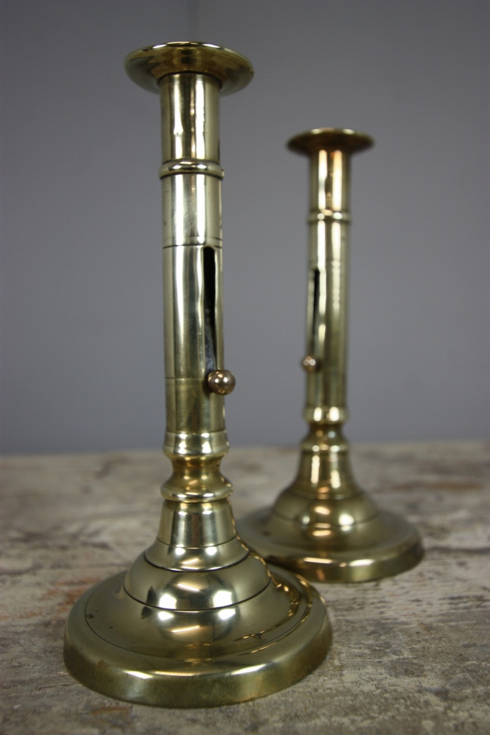 Pair of Georgian Antique Brass Push Up Candlesticks. 