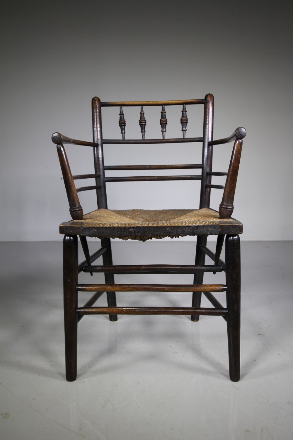 A True 19th Century Ebonised Antique Sussex Chair by William Morris