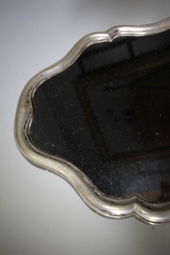 A 19th-century silver-gilt mirror featuring a contoured frame and an age-foxed glass plate. View III