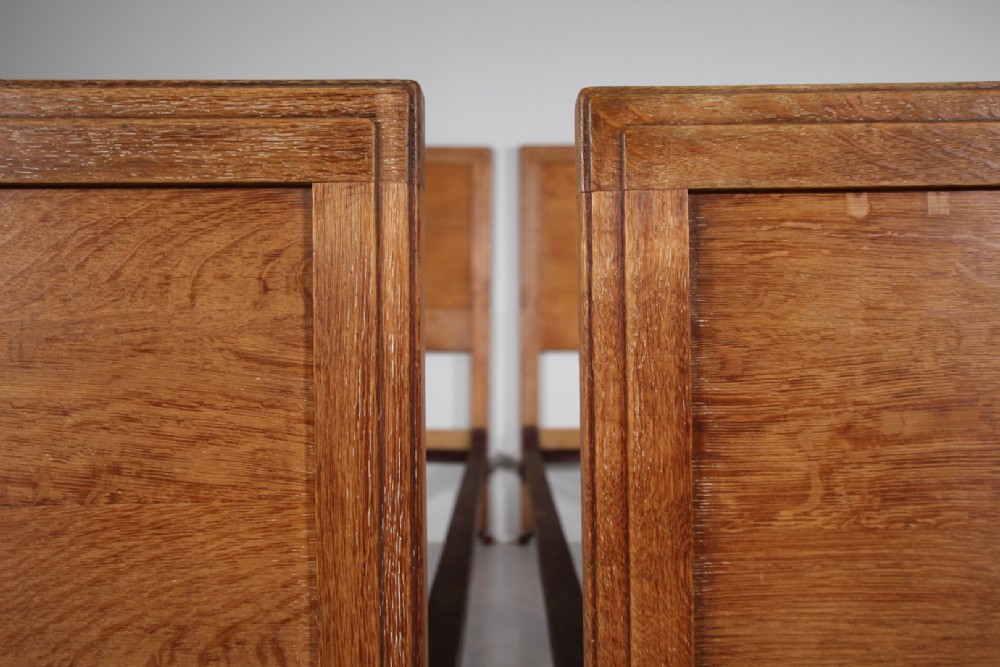 A pair of matching antique Arts and Crafts oak single bed frames with panelled headboards and footboards on castors. View VI
