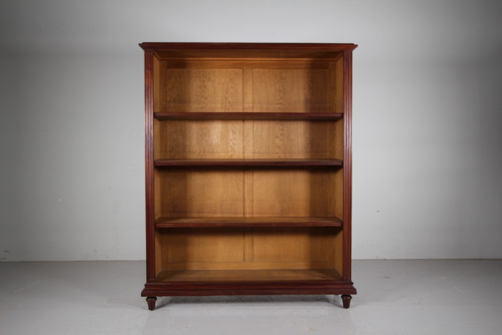 A large 19th-century mahogany open bookcase featuring diamond parquetry side panels, panelled backboards, four shelf sections, and turned feet. View IV