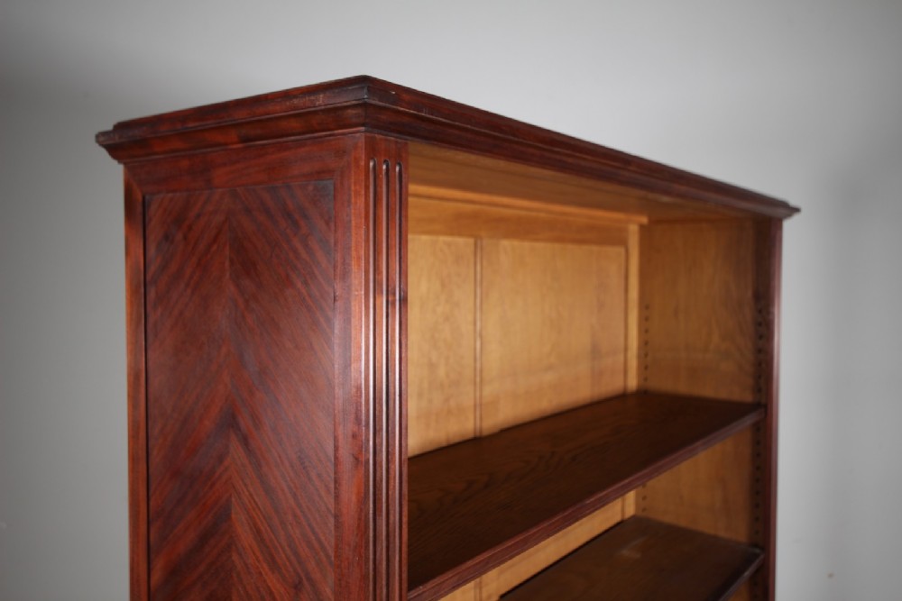 A large 19th-century mahogany open bookcase featuring diamond parquetry side panels, panelled backboards, four shelf sections, and turned feet. View V