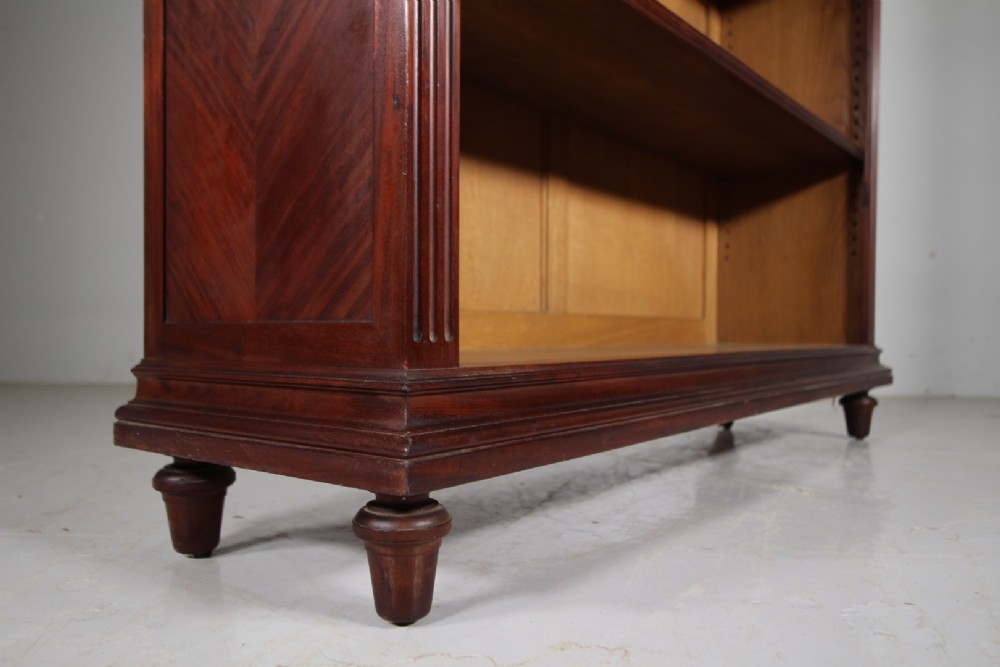 A large 19th-century mahogany open bookcase featuring diamond parquetry side panels, panelled backboards, four shelf sections, and turned feet. View VI
