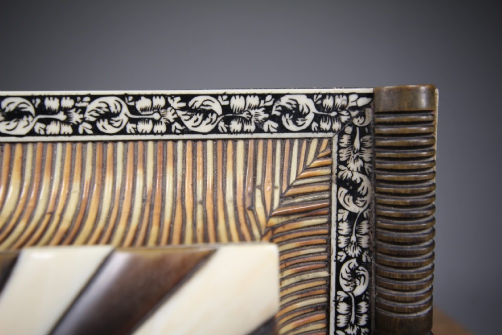 An antique sarcophagus-shaped porcupine quill box with engraved bone borders and bun feet. View V