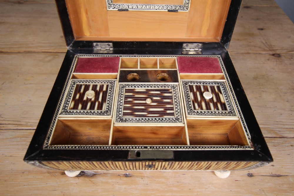 An antique sarcophagus-shaped porcupine quill box with engraved bone borders and bun feet. View VIII