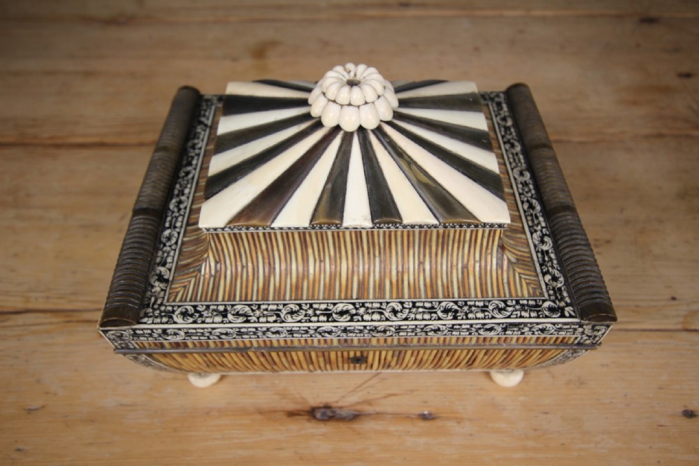An antique sarcophagus-shaped porcupine quill box with engraved bone borders and bun feet. View IX