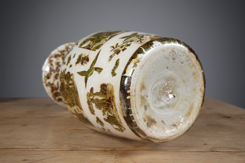 A 19th-century baluster-shaped glass vase featuring internal decalcomania imagery of figures, birds, and floral patterns against a cream background. View II