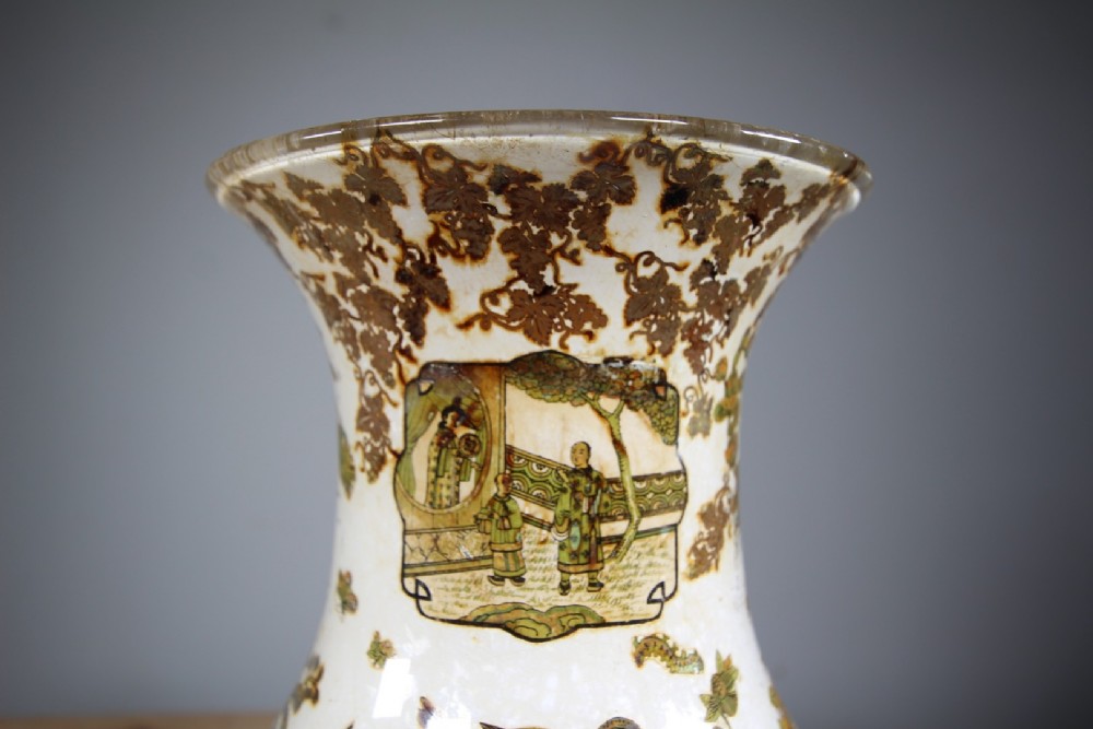 A 19th-century baluster-shaped glass vase featuring internal decalcomania imagery of figures, birds, and floral patterns against a cream background. View VI