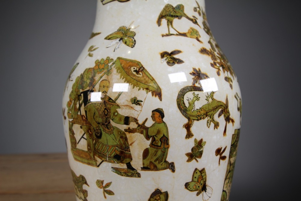 A 19th-century baluster-shaped glass vase featuring internal decalcomania imagery of figures, birds, and floral patterns against a cream background. View VIII