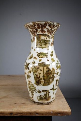A 19th-century baluster-shaped glass vase featuring internal decalcomania imagery of figures, birds, and floral patterns against a cream background.